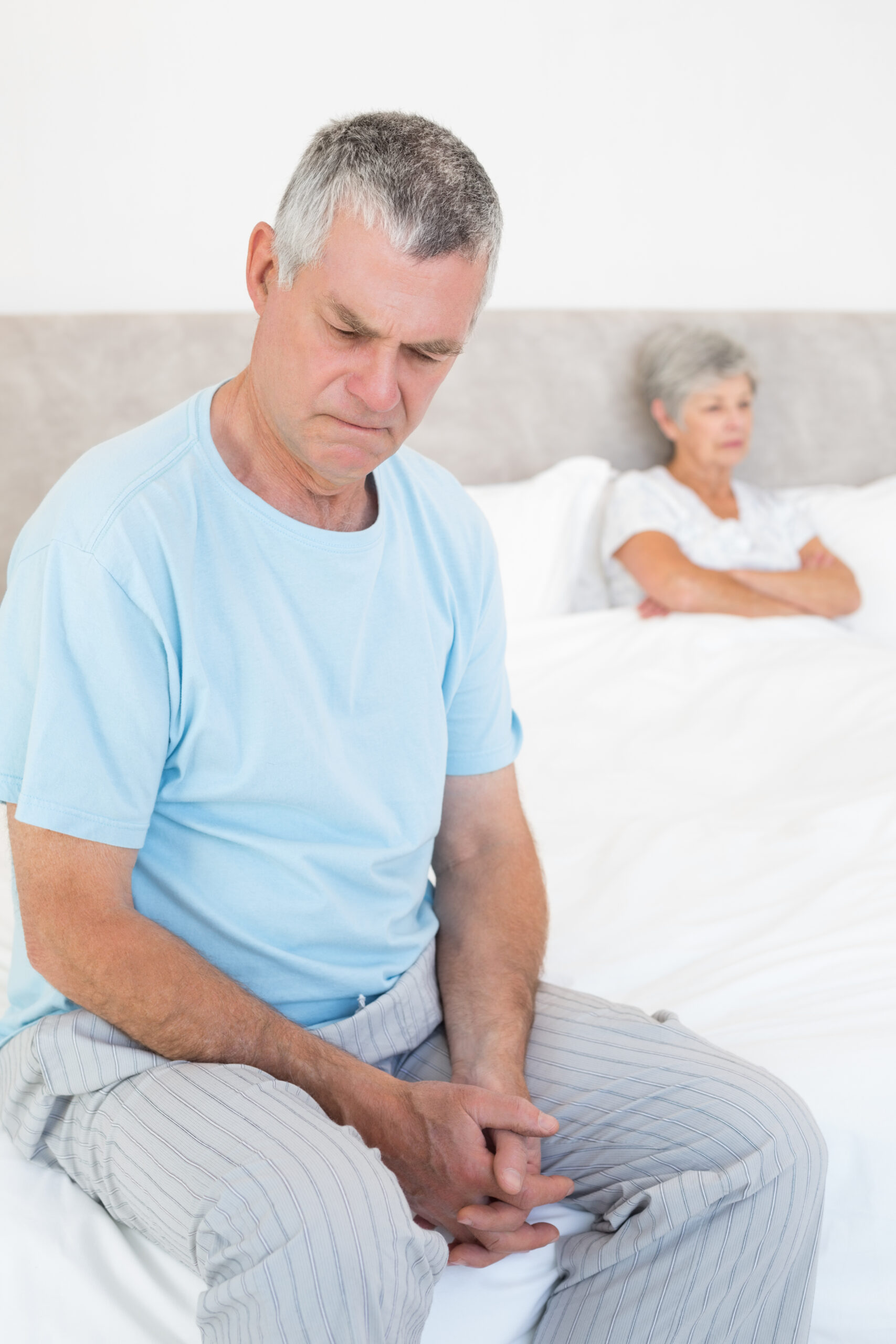 sad-senior-man-bed-with-wife-background-scaled.jpg